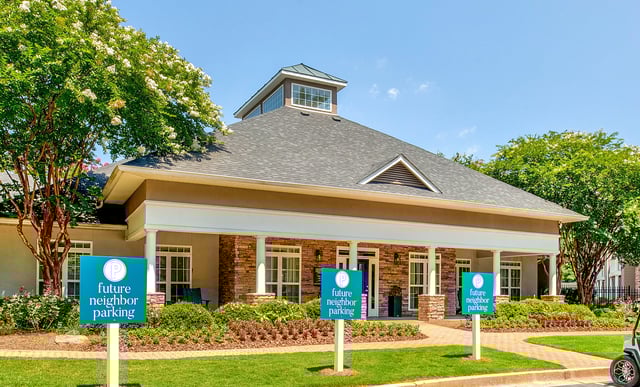 Building exterior with signage indicating future neighbor parking.
