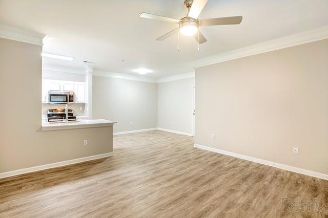 Spacious living room with a view of the kitchen.