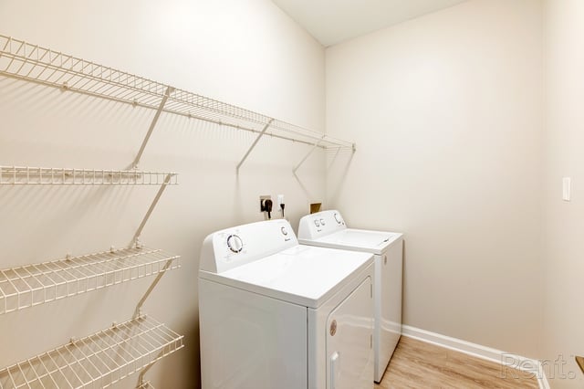 Laundry room with stacked washer and dryer and shelving