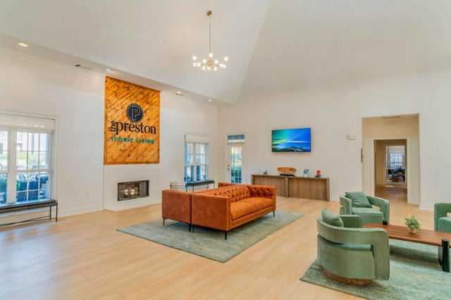 Lobby area with modern furniture and a fireplace.