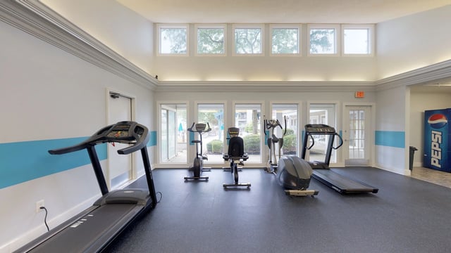 Fitness center with treadmills, ellipticals, and stationary bikes.