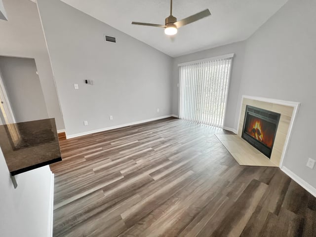 Living room with fireplace and vaulted ceiling