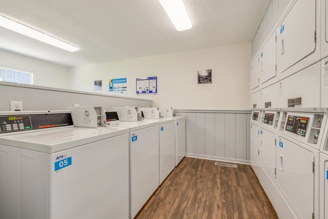Laundry room with commercial washers and dryers.