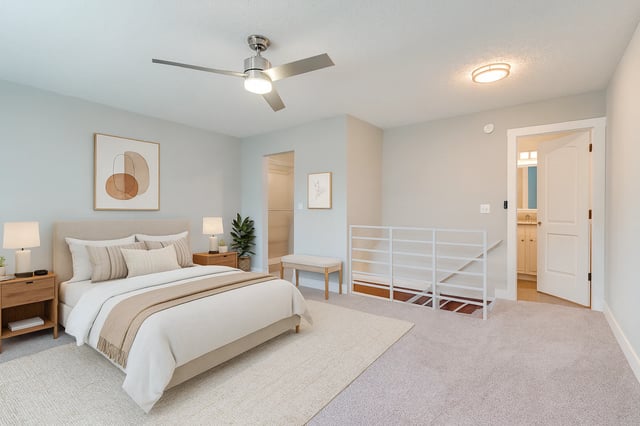Bedroom with a king-size bed, nightstands, ceiling fan, and access to a bathroom.