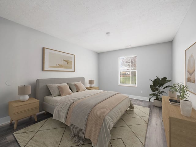 Bedroom with a king-size bed, bedside tables, and a dresser.