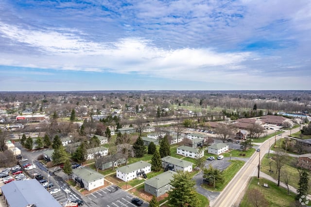 Aerial view of apartment buildings and surrounding neighborhood.