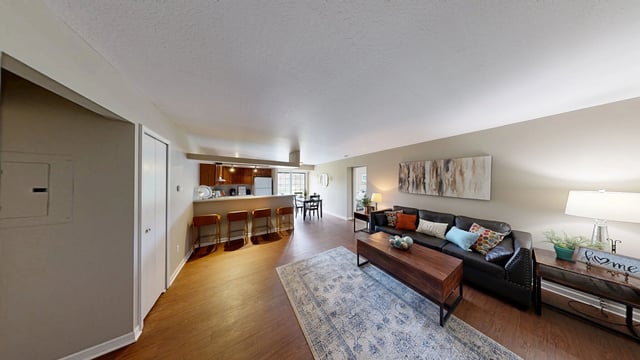 Living room and kitchen area of a multifamily apartment.