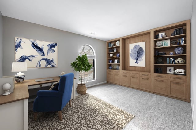 Cozy home office with built-in bookshelves, a desk, and a comfortable blue chair.