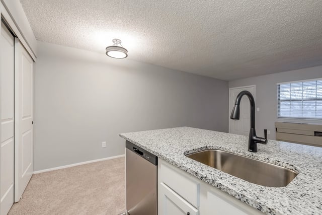 Kitchen island with sink and faucet.