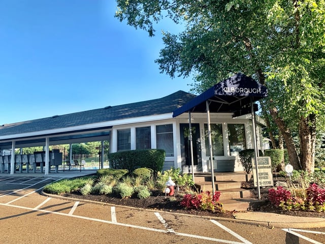 Kilborough apartment complex office building with blue awning