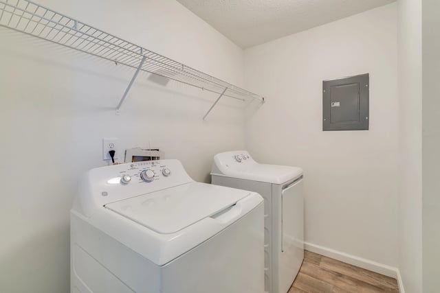 Washer and dryer in laundry closet with shelf