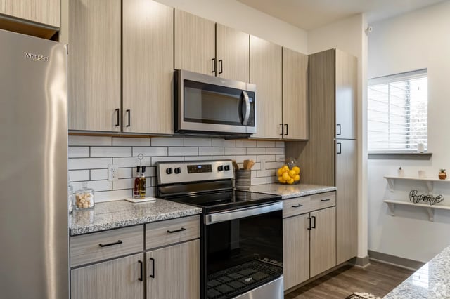 Modern kitchen with stainless steel appliances, ample cabinet space, and granite countertops.