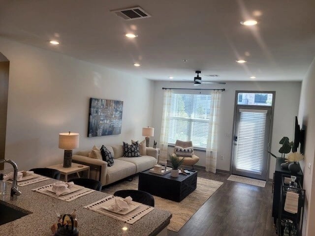 Interior of a living room with a couch, coffee table, and a kitchen island.