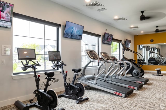 Fitness center with treadmills, stair climbers, and stationary bikes.