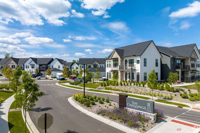 The Crossings apartment complex entrance sign and buildings
