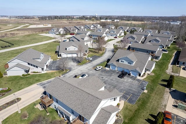 Aerial view of apartment buildings and parking lots.