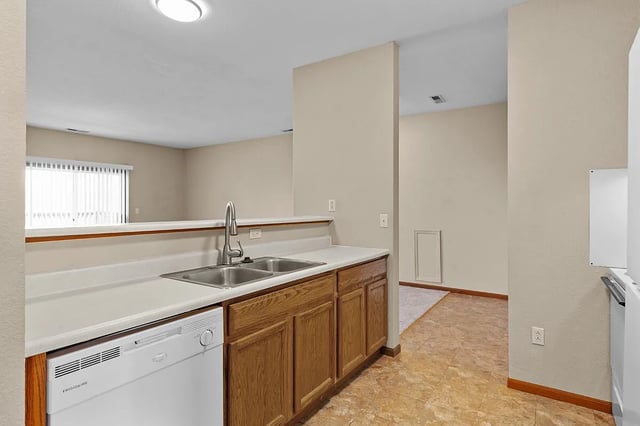 Kitchen with stainless steel sink and dishwasher.