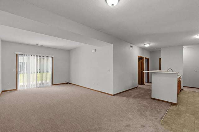 Spacious living area with sliding glass doors and a breakfast bar.