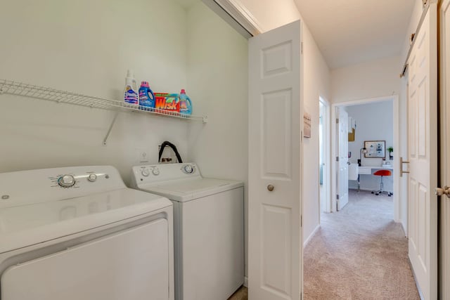 Washer and dryer in laundry closet.