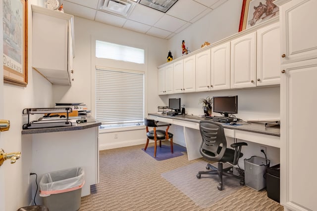 Business center with two workstations, computers, and printers.