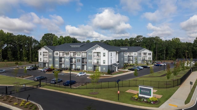 Exterior view of Novo at Woodbridge apartment complex with a monument sign.