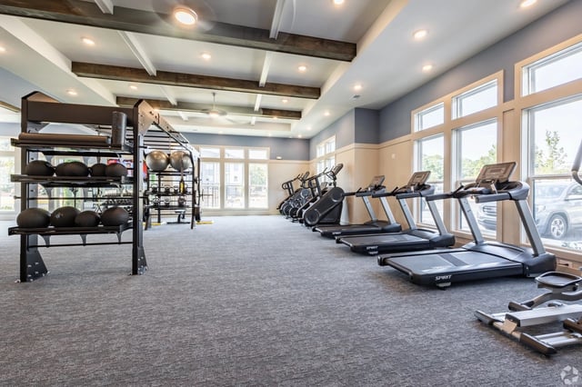 Fitness center with treadmills, stair climbers, and free weights.