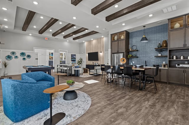 Community lounge area with a pool table, seating, and a bar.