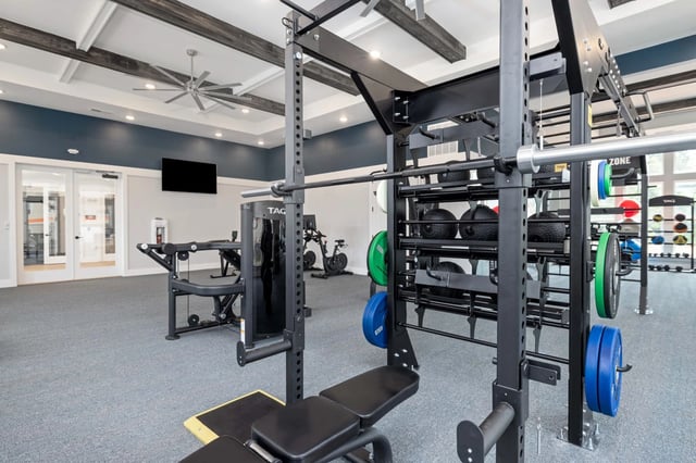 Fully equipped fitness center with weight machines, free weights, and cardio equipment.