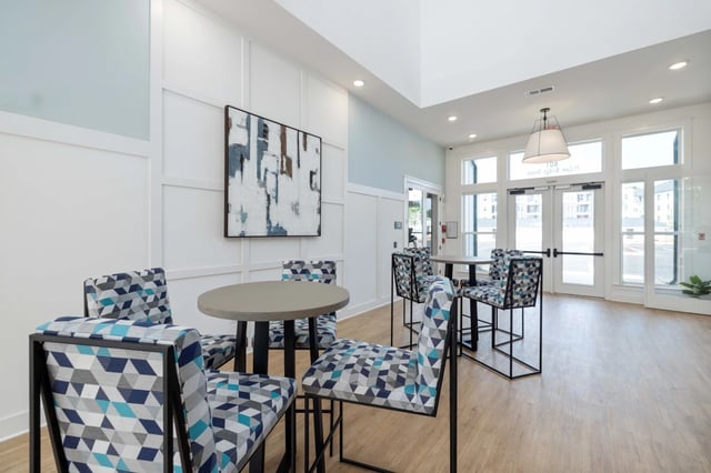Community lounge area with high-top tables and chairs.
