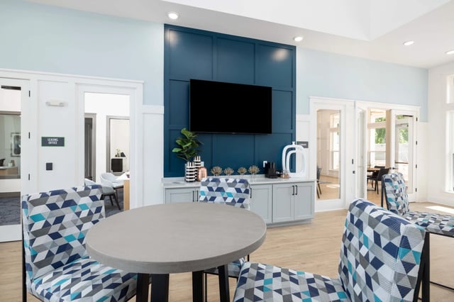 Community lounge area with coffee station and seating.