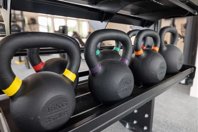 Row of kettlebells in a gym.