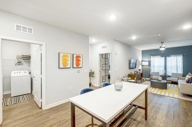 Modern open-concept living area with kitchen island, laundry room, and living room.