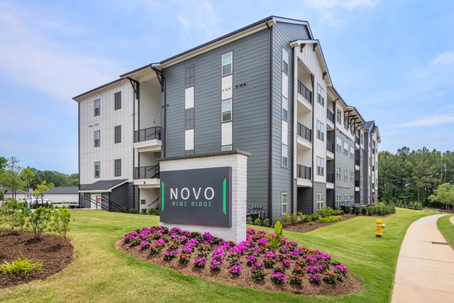 Novo Blue Ridge apartment building exterior with monument sign and landscaping.