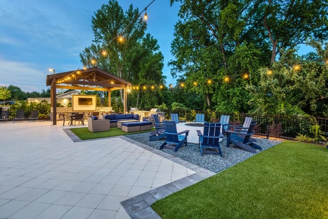 Outdoor patio with fire pit, lounge seating, grills, and covered entertainment area.