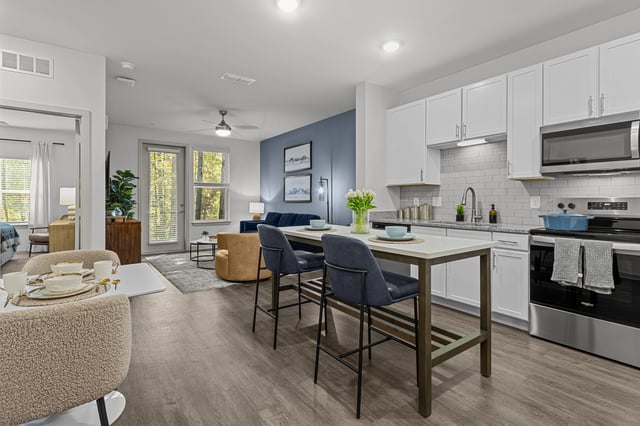 Modern kitchen with island seating and open living area.