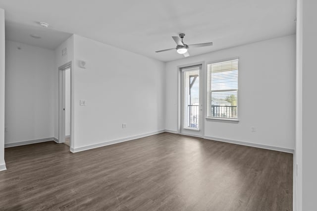 Living room with ceiling fan and balcony access