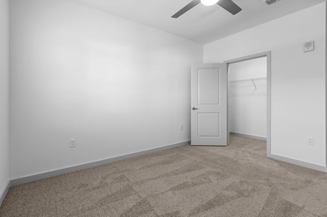 Bedroom with carpet, ceiling fan, and open closet.