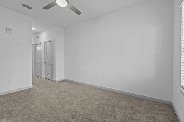 Bedroom with carpet and ceiling fan.