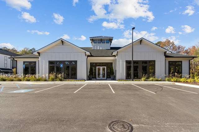 Exterior of the community building with parking lot in foreground