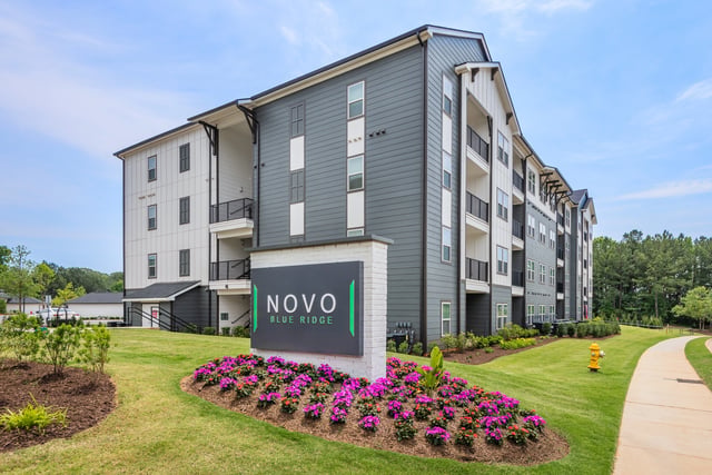 Novo Blue Ridge apartment building exterior with signage and landscaping.