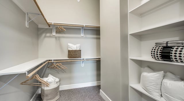 Walk-in closet with shelves and hanging rods.