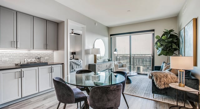 Modern dining area and living room with balcony access