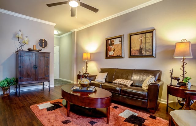 Living room with leather sofa, coffee table, and decor.