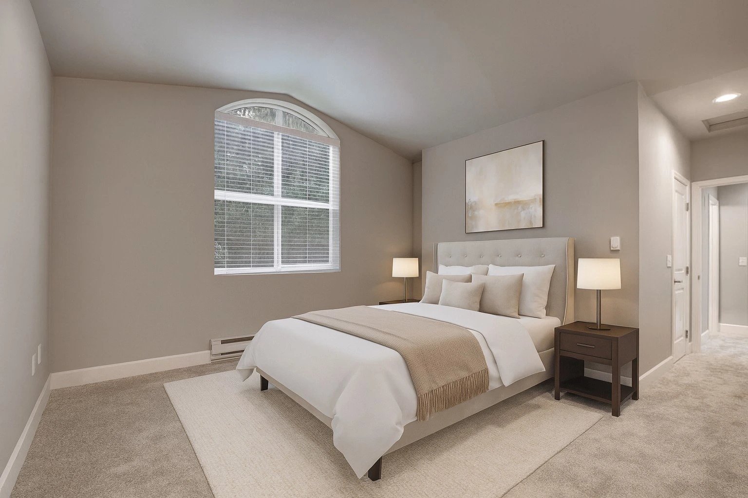 Neutral-toned apartment bedroom with a large arched window, bed, and two nightstands.