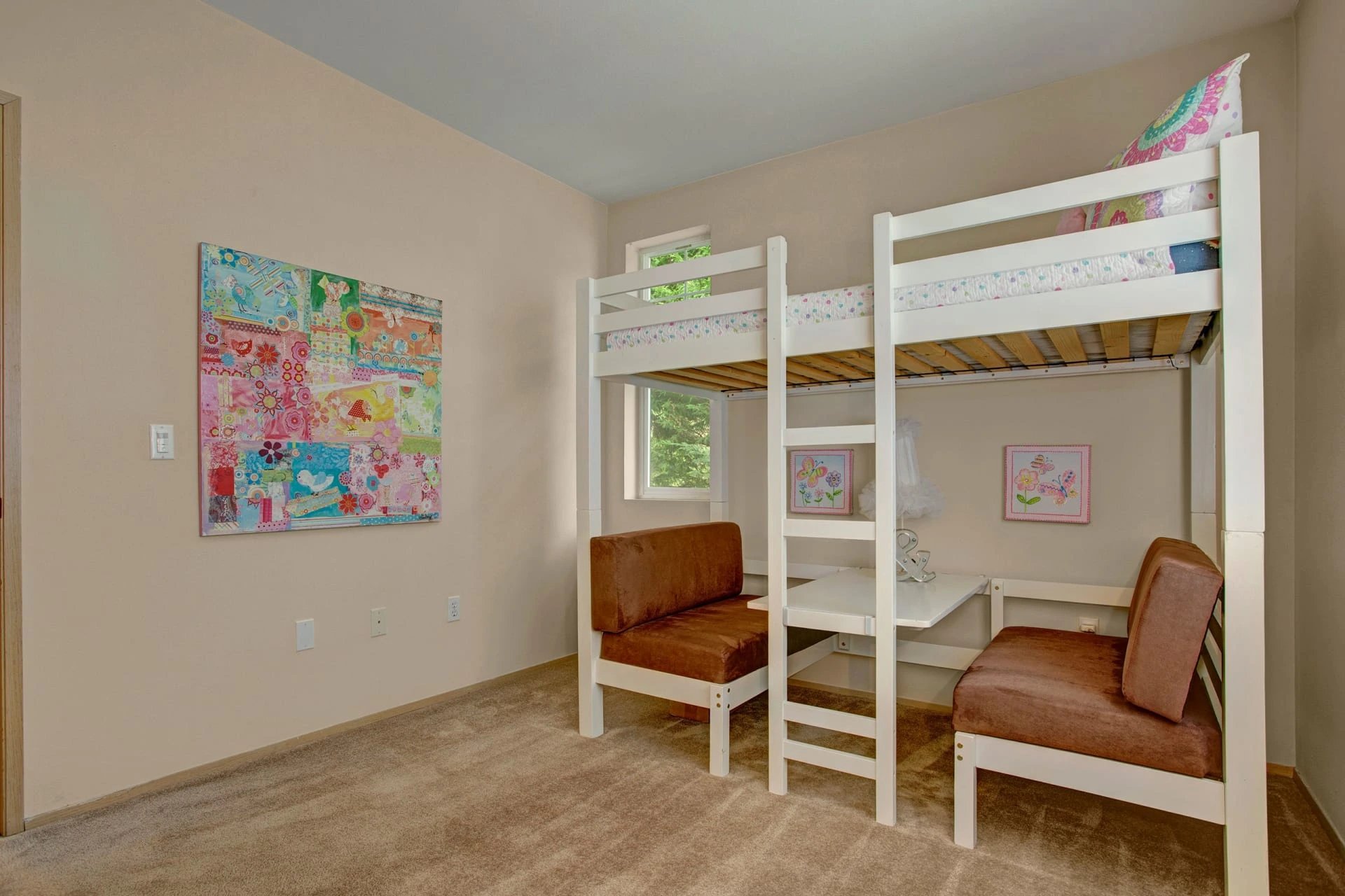 White wooden bunk bed with built-in desk and brown cushioned benches in a beige kids' bedroom.