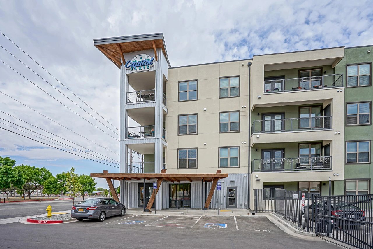 Capitol Flats apartment building exterior with a car parked in the lot.
