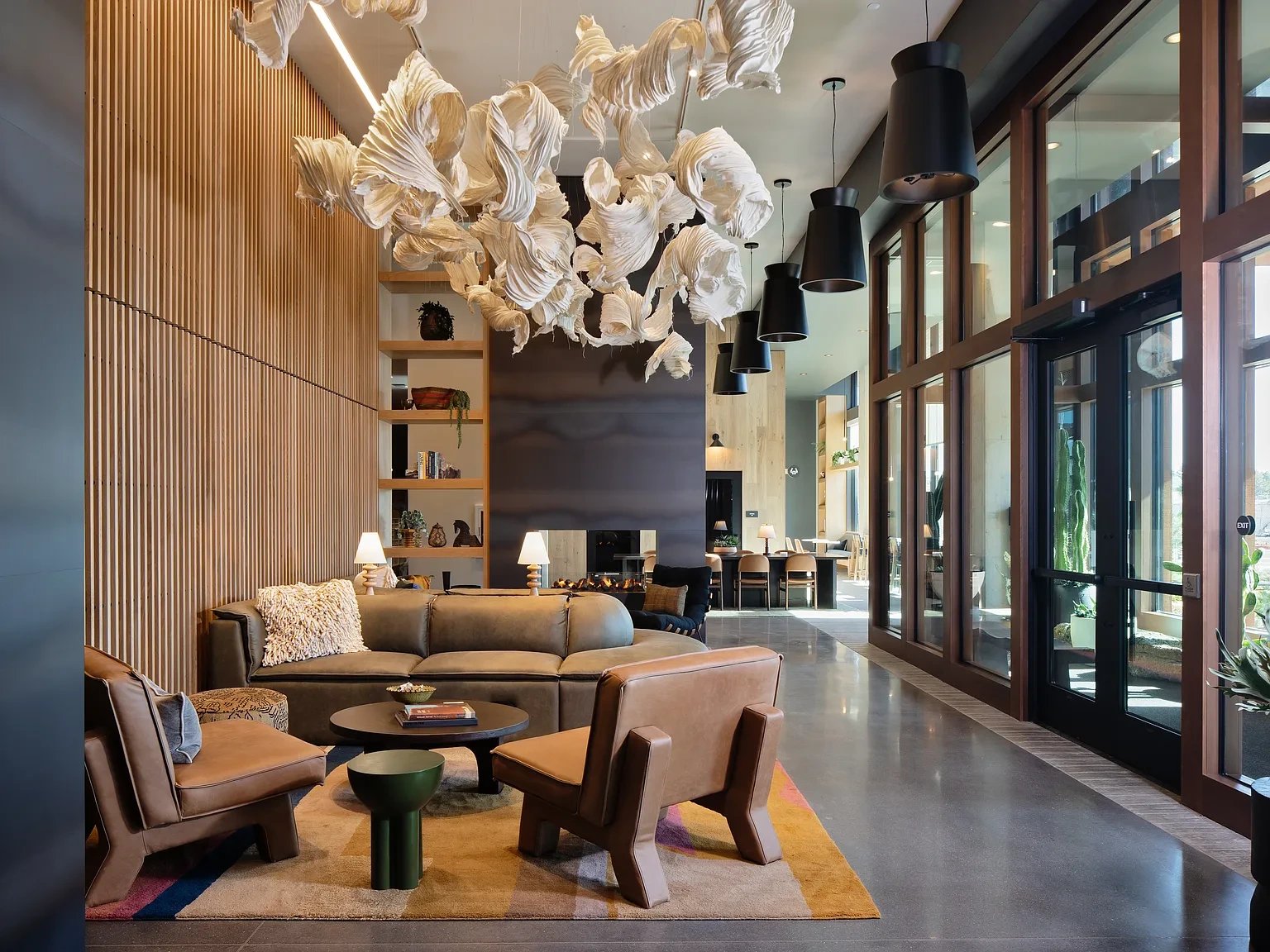 Modern apartment living room with a blue sofa, fireplace, and built-in shelving.