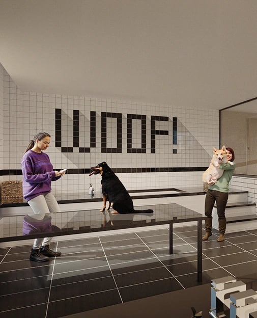 Two people with dogs in a tiled lobby; a black dog sits on a bench while one person holds a small corgi.